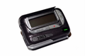 3903 AI Pager, Classic model: a black alphanumeric belt pager with a grey LCD screen, four navigation buttons and a green status light, shown at an angle on a white background.